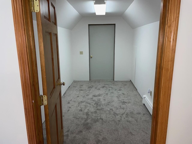 bonus room featuring a baseboard heating unit, vaulted ceiling, and carpet flooring
