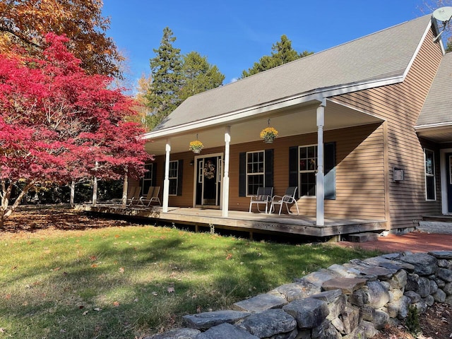 view of front of house featuring a front yard and covered porch