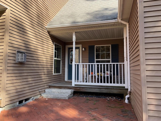 view of exterior entry featuring covered porch