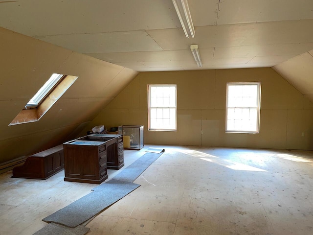 bonus room featuring vaulted ceiling with skylight