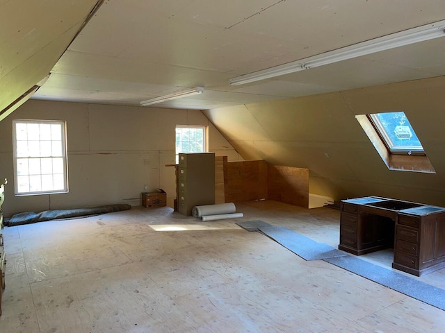 bonus room featuring vaulted ceiling with skylight