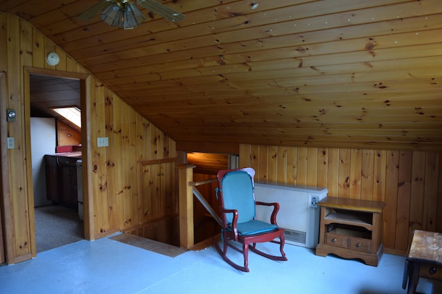 living area featuring wooden walls, ceiling fan, vaulted ceiling, and wooden ceiling