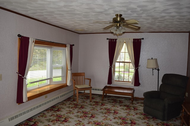 living area featuring a baseboard heating unit, a wealth of natural light, ceiling fan, and a textured ceiling