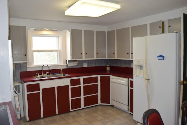 kitchen featuring tasteful backsplash, white appliances, light tile flooring, sink, and radiator heating unit