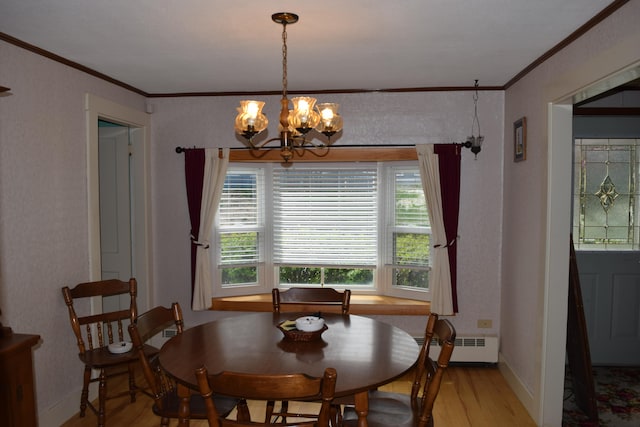 dining space featuring a baseboard heating unit, a notable chandelier, ornamental molding, and light hardwood / wood-style flooring