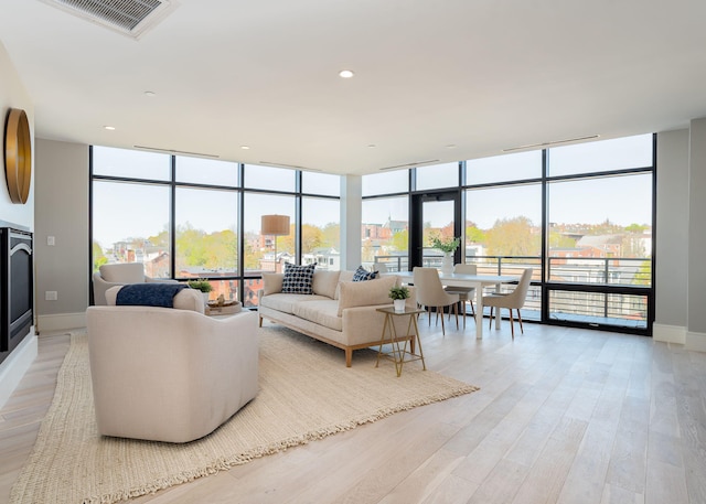 387 Commercial St Unit 709, Portland, ME 04101 - living area with floor to ceiling windows, baseboards, and light wood-style floors
