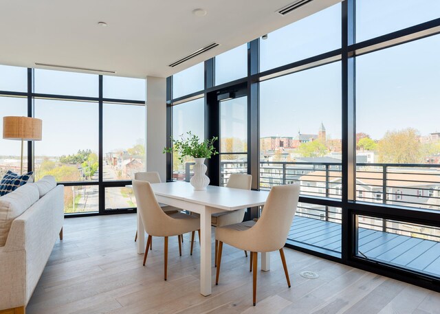 387 Commercial St Unit 709, Portland, ME 04101 - dining space featuring expansive windows and light wood-style floors