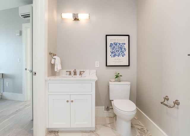 387 Commercial St Unit 709, Portland, ME 04101 - bathroom featuring a wall unit AC, baseboards, toilet, and vanity