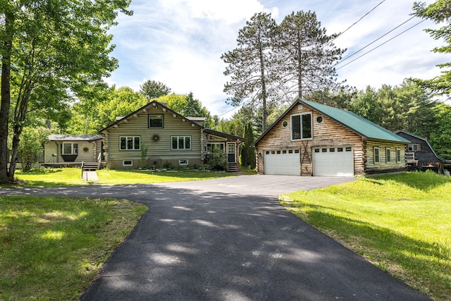 log home featuring a garage and a front lawn