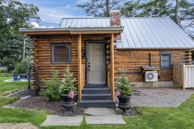 view of front of house with ac unit and a front yard