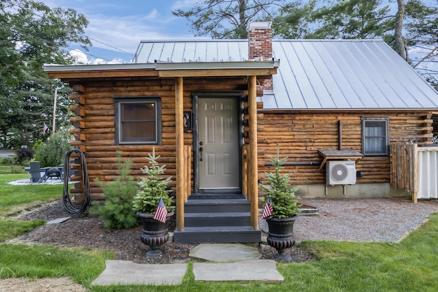 114 Fort Rd, Edgecomb, ME 04556 - entrance to property with ac unit, a chimney, a standing seam roof, metal roof, and log exterior