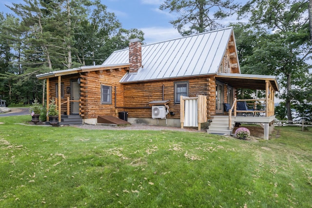 114 Fort Rd, Edgecomb, ME 04556 - rear view of property with a standing seam roof, a yard, metal roof, and log siding
