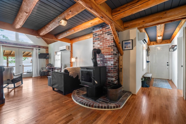 living room featuring wood ceiling, hardwood / wood-style flooring, a wood stove, and french doors