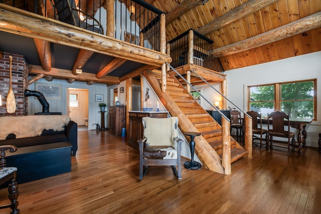 114 Fort Rd, Edgecomb, ME 04556 - living area featuring stairs, hardwood / wood-style floors, beamed ceiling, and a wood stove