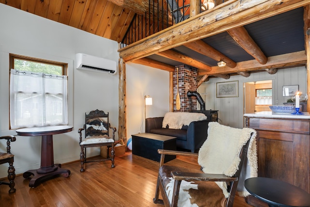 114 Fort Rd, Edgecomb, ME 04556 - living area featuring wood ceiling, baseboards, a wall mounted AC, beam ceiling, and wood-type flooring