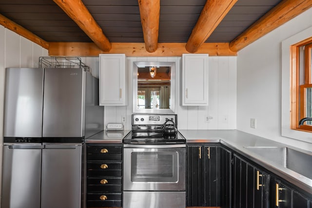 kitchen featuring stainless steel appliances, beam ceiling, and white cabinets