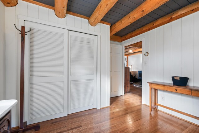 interior space with wooden ceiling, wood-type flooring, and beam ceiling