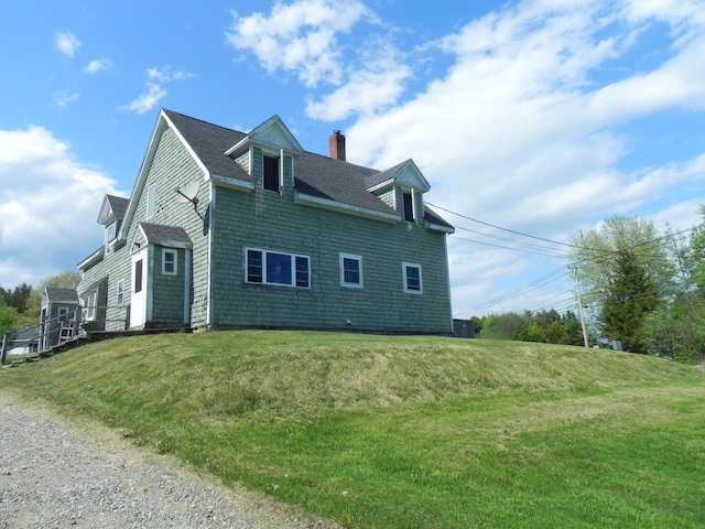 view of home's exterior with a yard