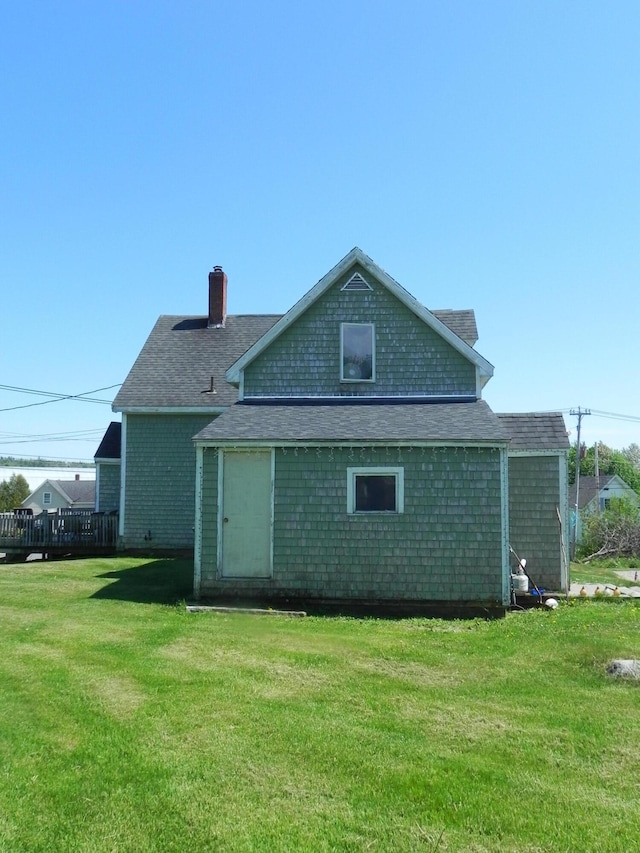 rear view of house with a yard