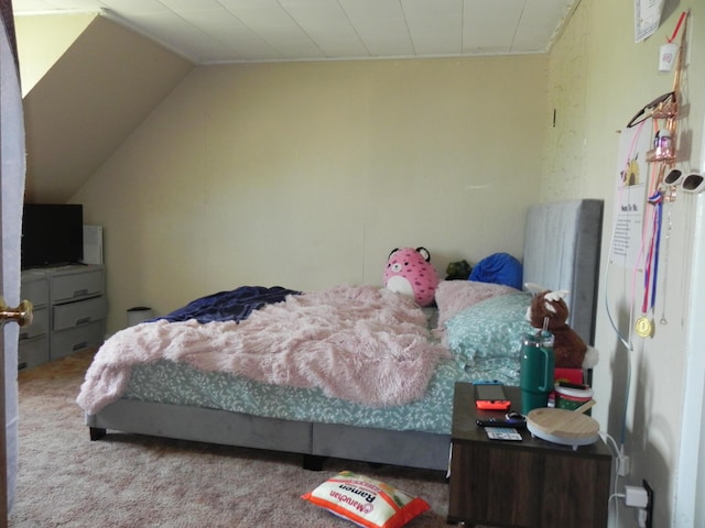 bedroom featuring vaulted ceiling and carpet flooring