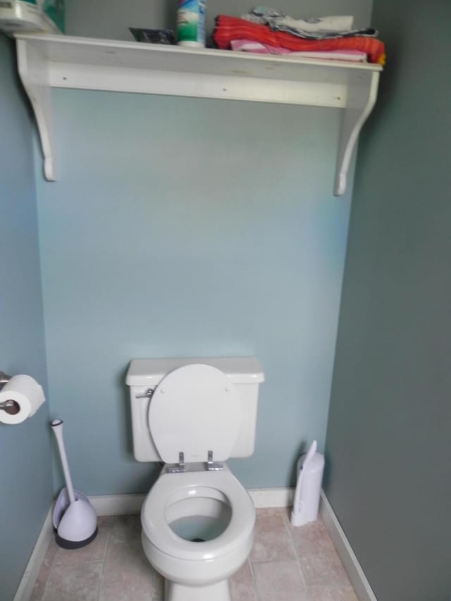 bathroom with toilet and tile patterned flooring