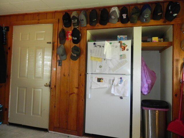 kitchen with wooden walls and white fridge