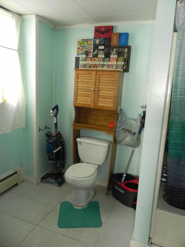 bathroom with toilet, shower / bath combo, and a baseboard radiator