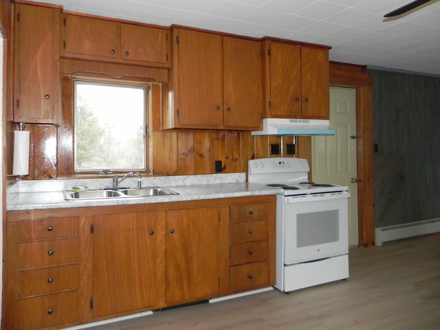 kitchen with a sink, a baseboard heating unit, light countertops, under cabinet range hood, and white electric stove
