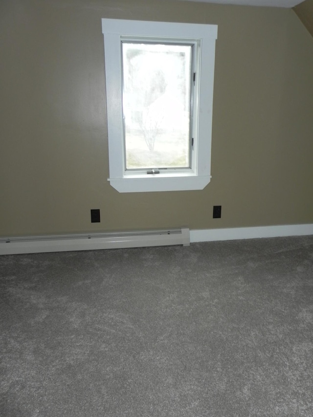 interior space with baseboards, baseboard heating, and carpet flooring