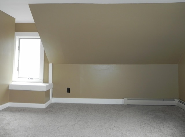 bonus room featuring baseboard heating, light carpet, vaulted ceiling, and baseboards