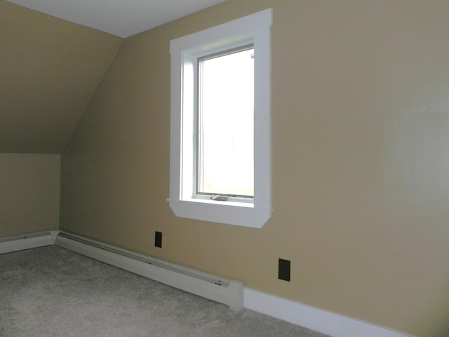 bonus room with a baseboard radiator, vaulted ceiling, carpet, and baseboards