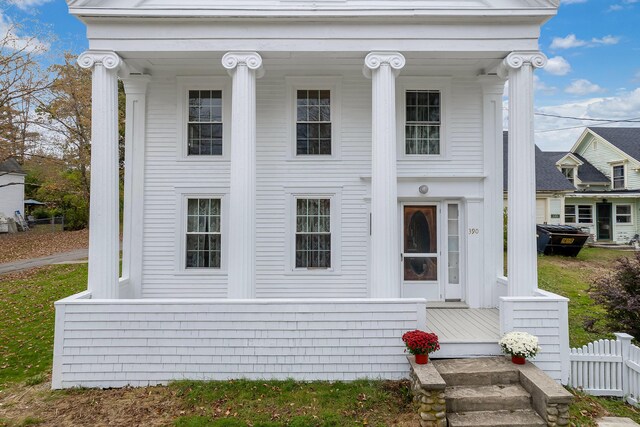 neoclassical home featuring a porch