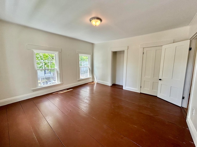 unfurnished bedroom featuring dark wood-type flooring