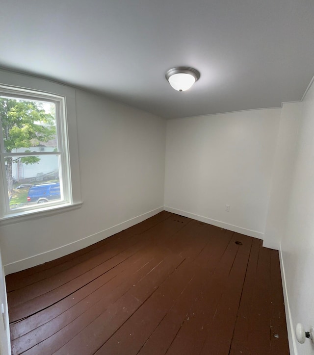 unfurnished room featuring dark wood-type flooring