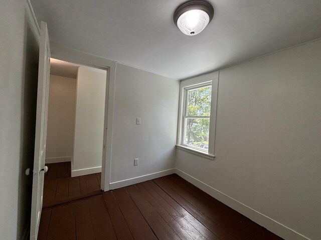 unfurnished bedroom featuring dark wood-type flooring