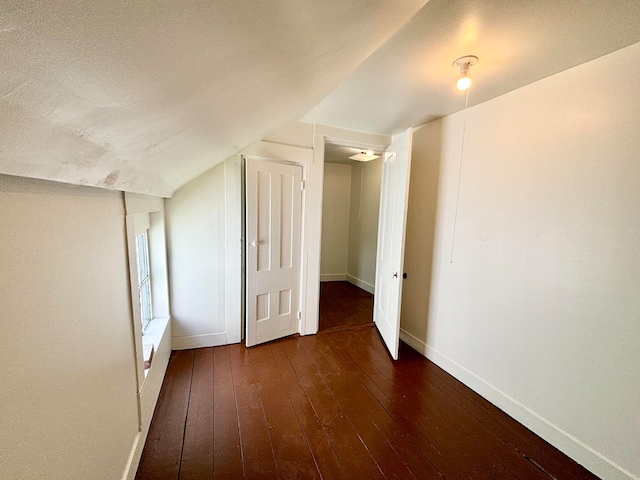 bonus room featuring lofted ceiling and hardwood / wood-style flooring