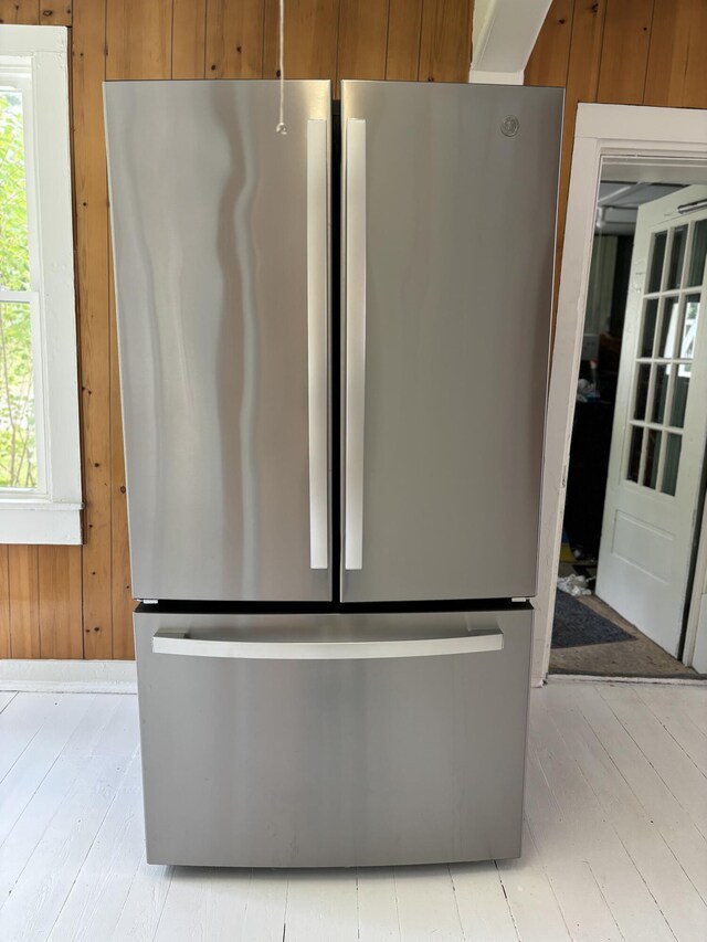 room details with wood walls and stainless steel fridge