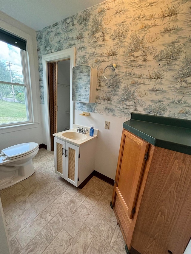 bathroom featuring tile patterned floors, vanity, and toilet