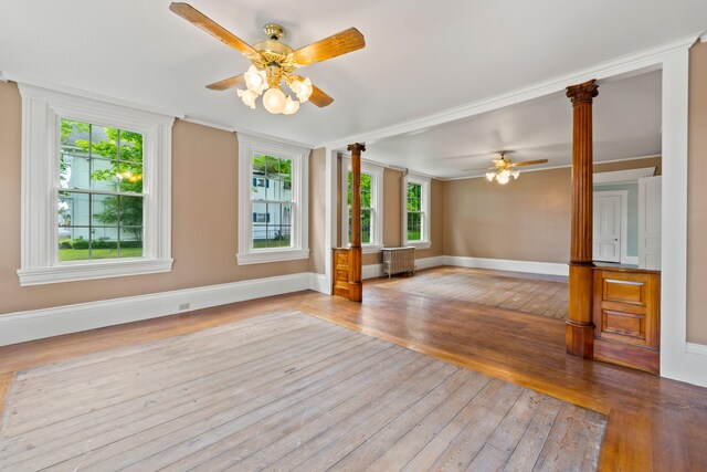 spare room featuring ceiling fan, light hardwood / wood-style flooring, a wealth of natural light, and radiator