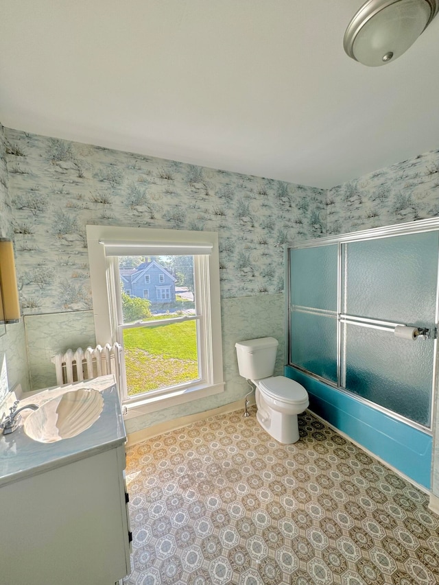 bathroom featuring toilet, vanity, and tile patterned flooring