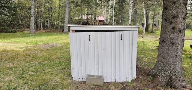 view of outbuilding featuring a lawn