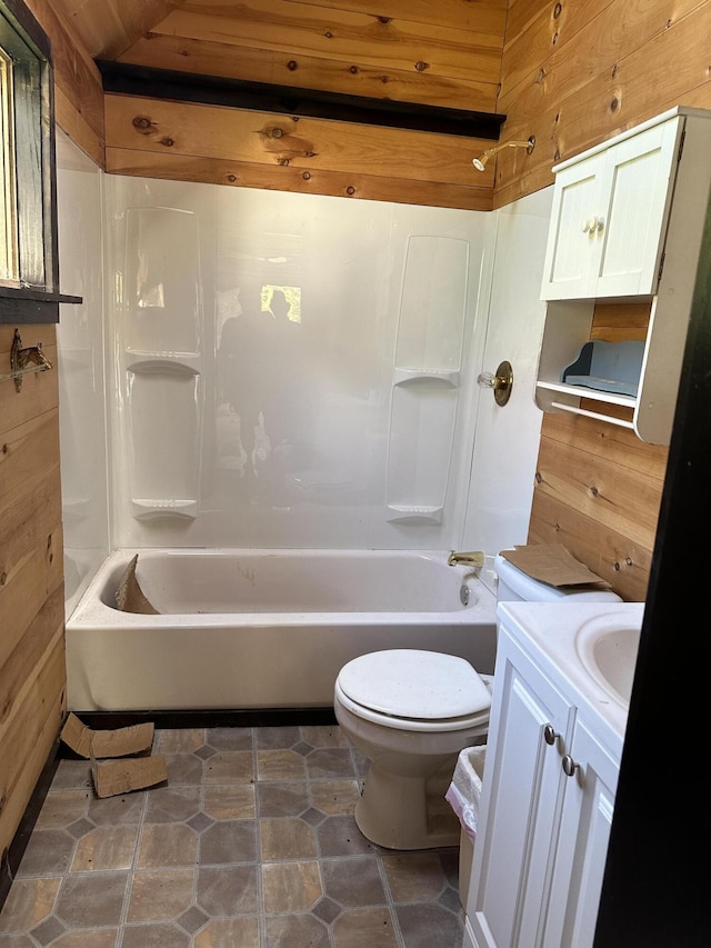 full bathroom with toilet, wood walls, wooden ceiling, washtub / shower combination, and vanity