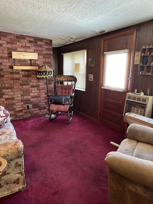 carpeted living room with a textured ceiling and wooden walls