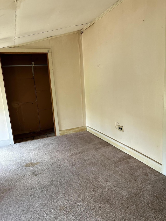 unfurnished bedroom with a closet and carpet flooring