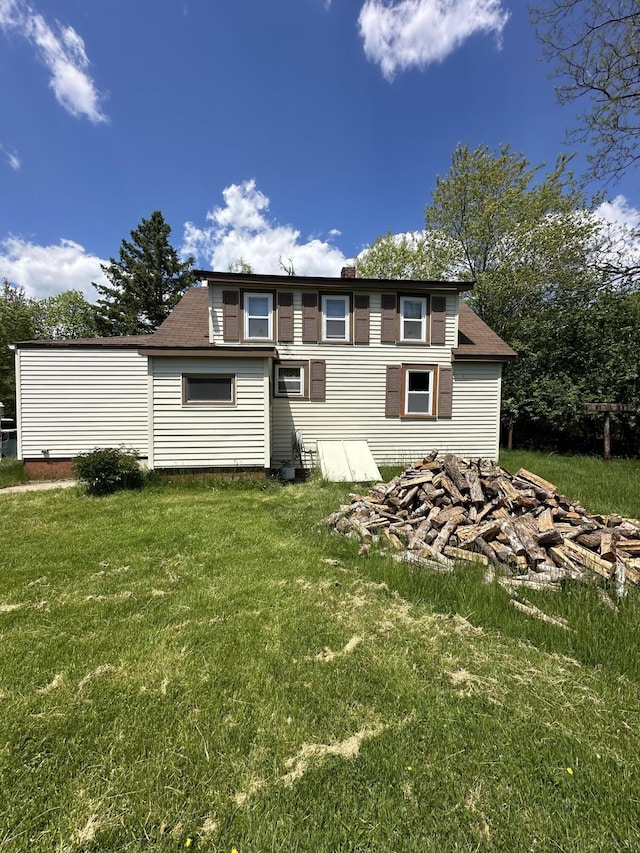 rear view of house with a lawn