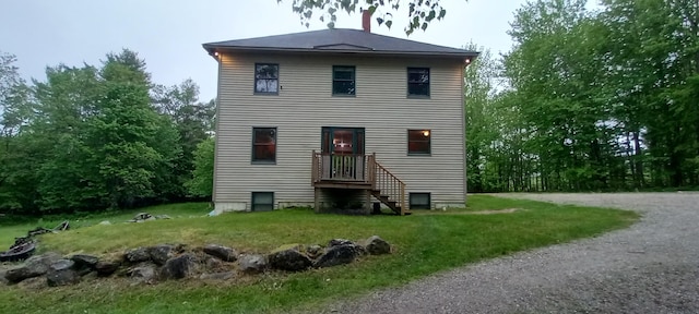 back of property featuring a yard