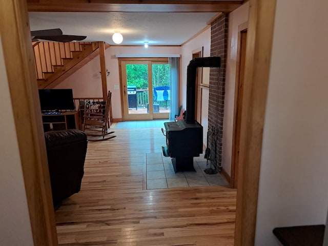 corridor with light hardwood / wood-style flooring and crown molding