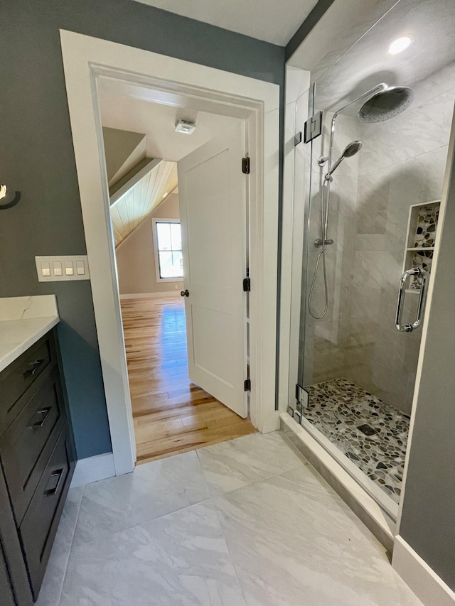 bathroom with vanity and a shower with door