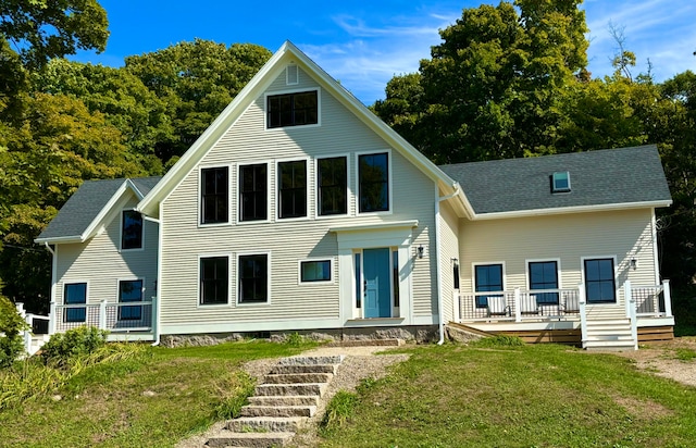 back of house with a lawn and a porch