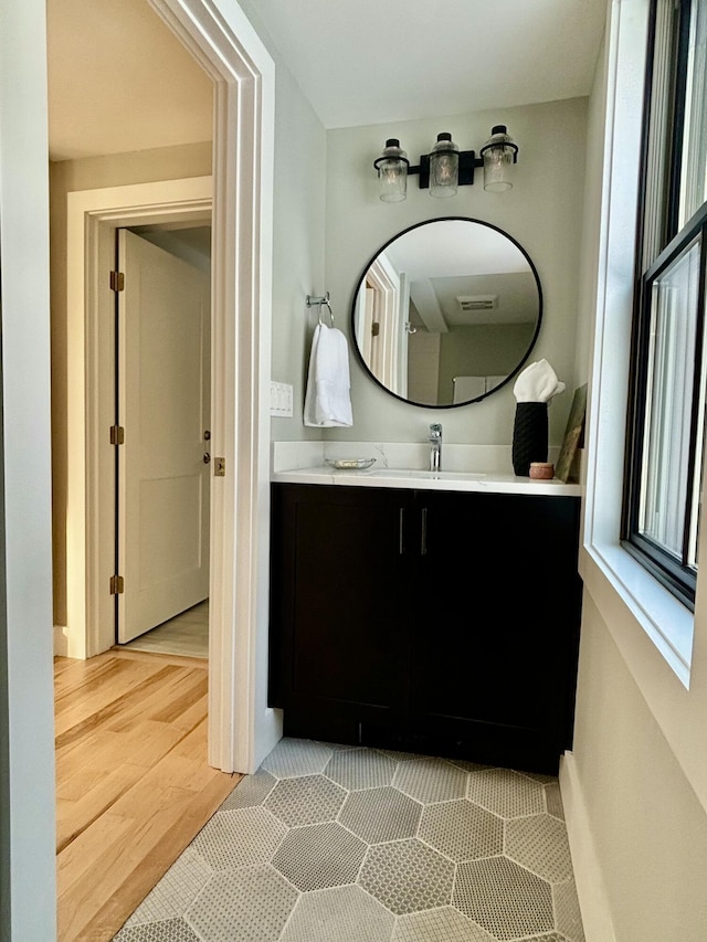 bathroom with vanity and hardwood / wood-style floors